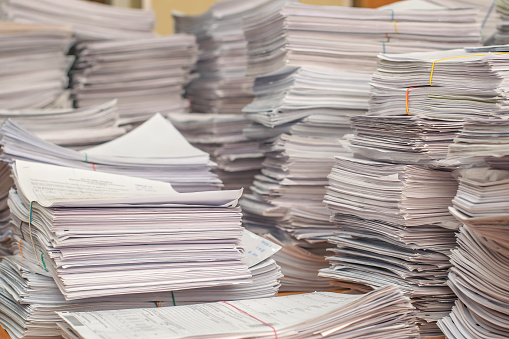 Bundles Bales Of Paper Documents. Stacks Packs Pile On The Desk In The Office